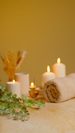 Vertical-Video-Still-Life-Of-Lit-Candles-With-Dried-Grasses-Incense-Stick-And-Soft-Towels-As-Part-Of-Relaxing-Spa-Day-Decor-2